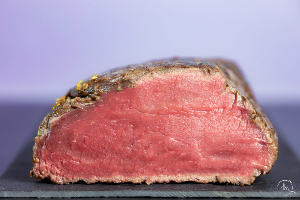 Gros plan sur la coupe du Cœur de Rumsteck Angus saisi, croûte dorée et intérieur rosé